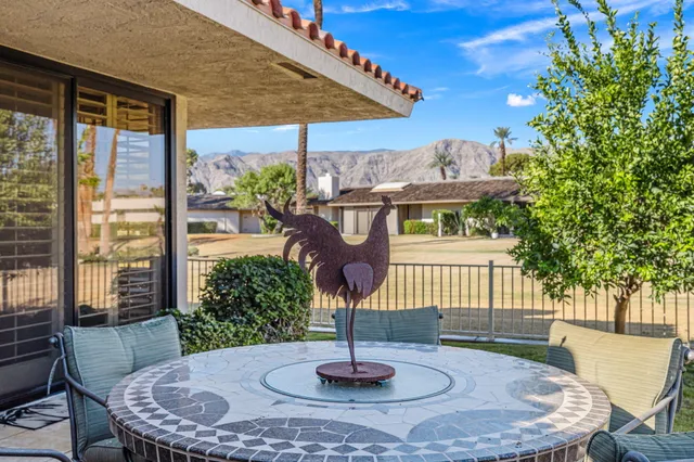 a dining room with furniture a chandelier and wooden floor