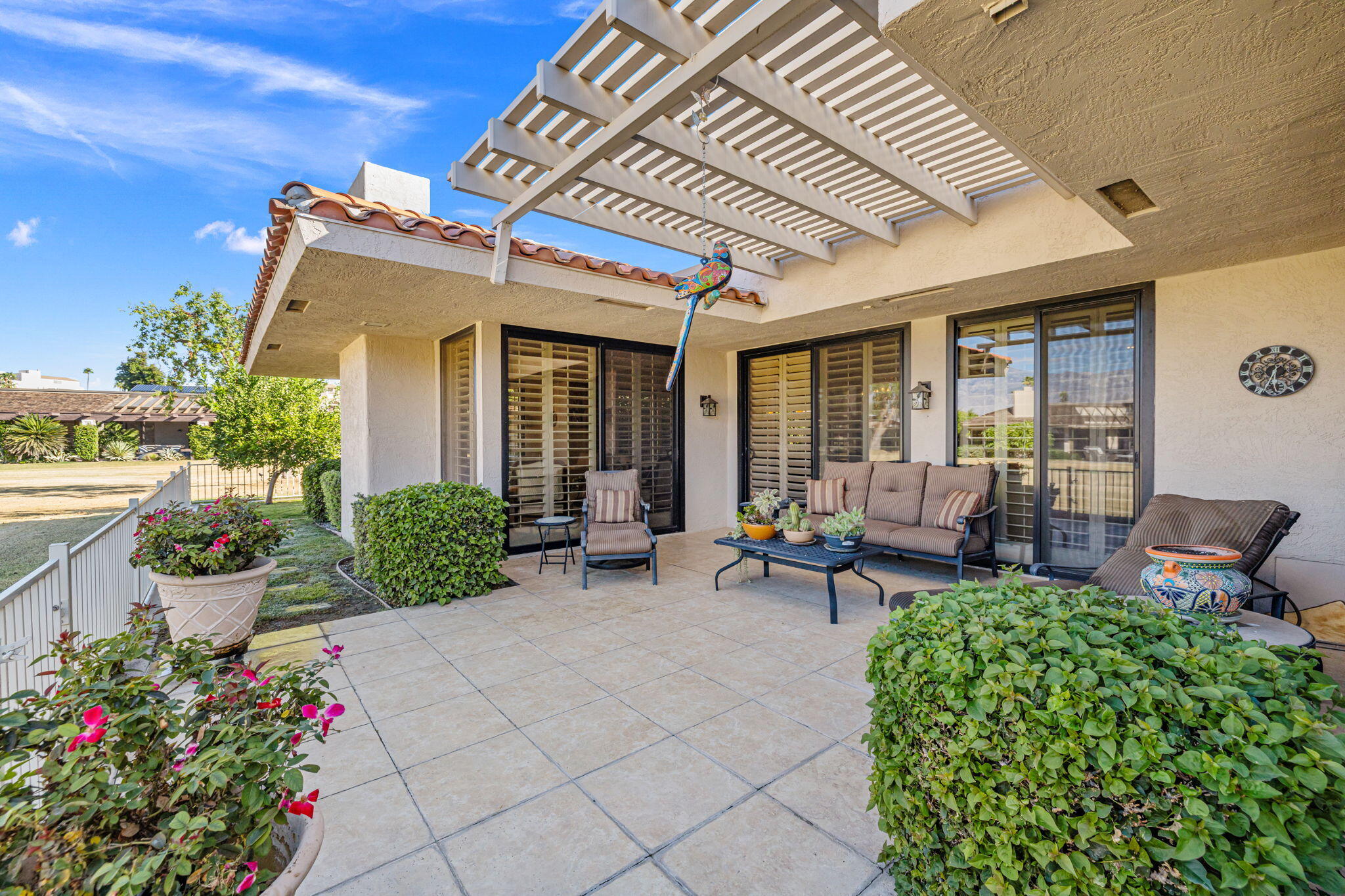 10 Whittier Court Rancho Mirage, CA 92270 - Photo 29 of 88 a view of a patio with table and chairs and potted plants