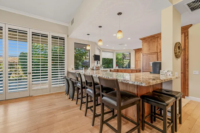 a kitchen with granite countertop white cabinets and white appliances