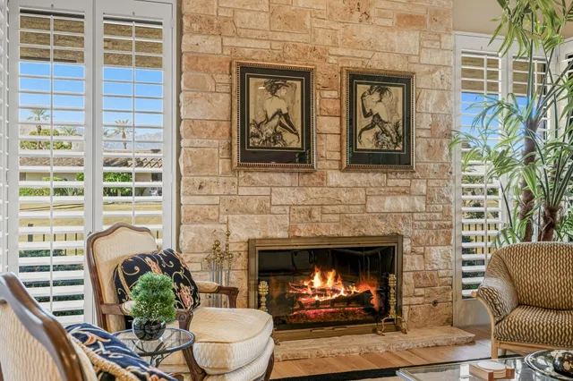 a spacious bathroom with a granite countertop sink a mirror a window and a bathtub