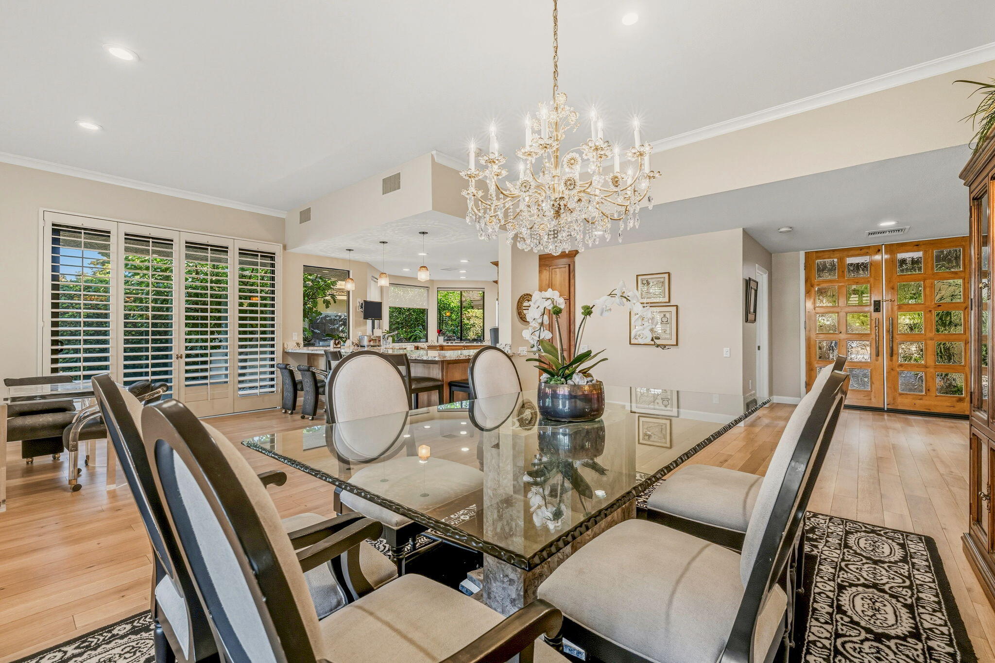 10 Whittier Court Rancho Mirage, CA 92270 - Photo 39 of 88 a dining room with furniture a chandelier and wooden floor