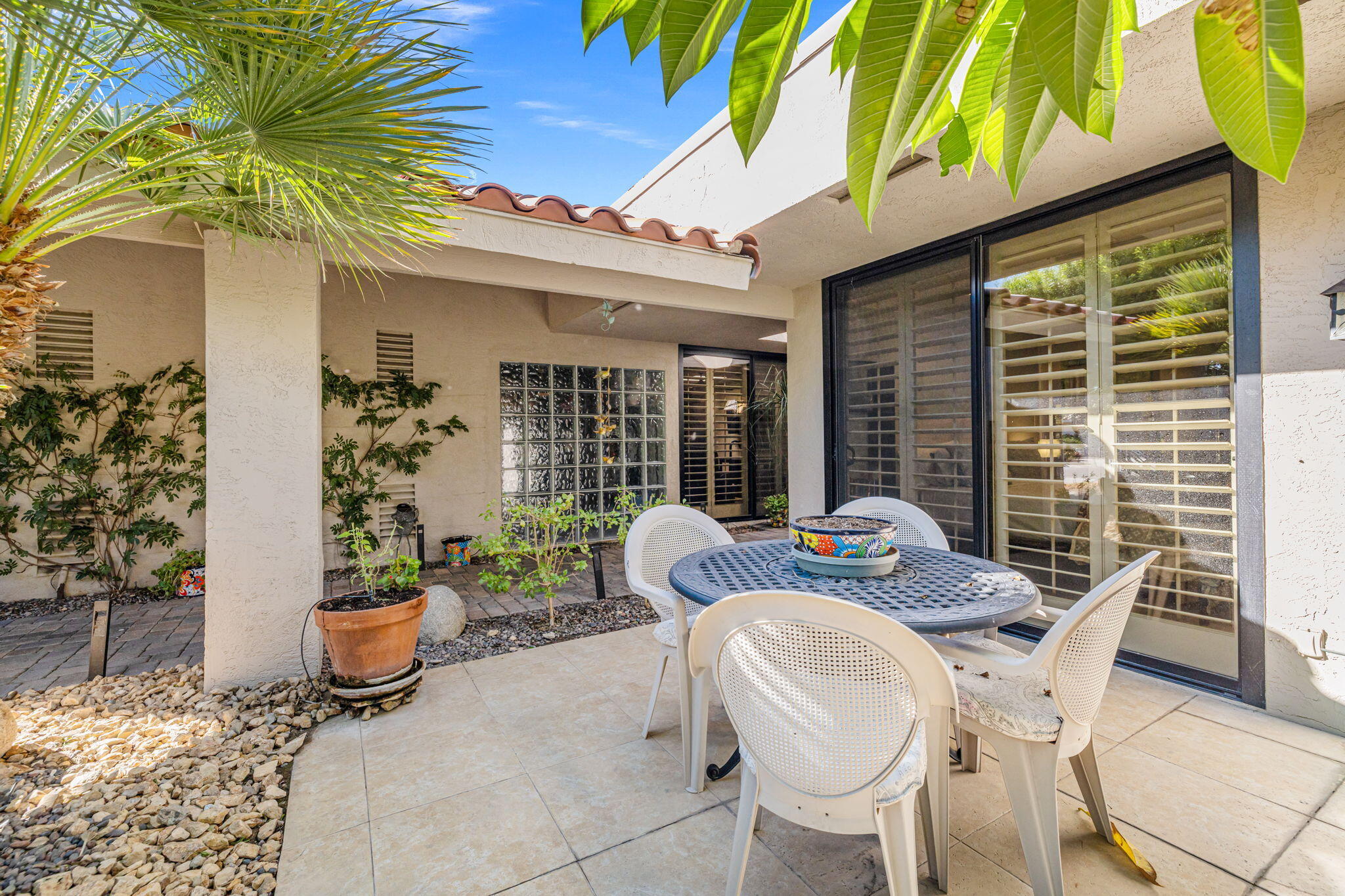 10 Whittier Court Rancho Mirage, CA 92270 - Photo 4 of 88 a view of a patio with couple of chairs and potted plants