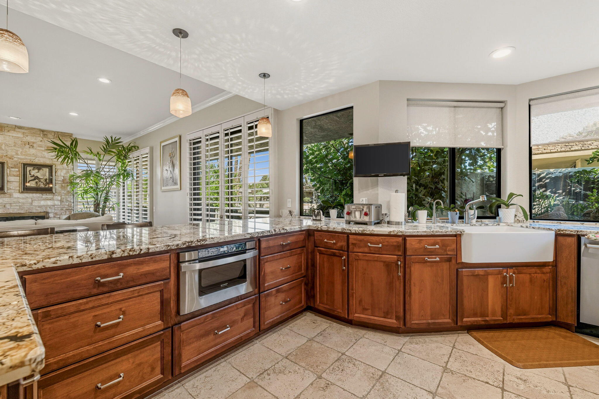 10 Whittier Court Rancho Mirage, CA 92270 - Photo 47 of 88 a kitchen with stainless steel appliances granite countertop a stove a sink and a microwave