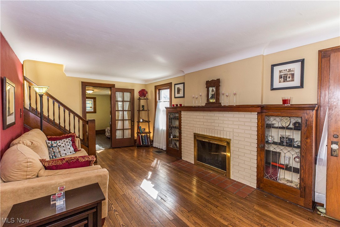 1577 Maple Road Cleveland Heights, OH 44121 - Photo 3 of 30 Living area featuring stairs, hardwood floors, and a fireplace