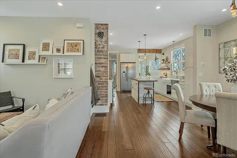 a dining room with furniture and wooden floor