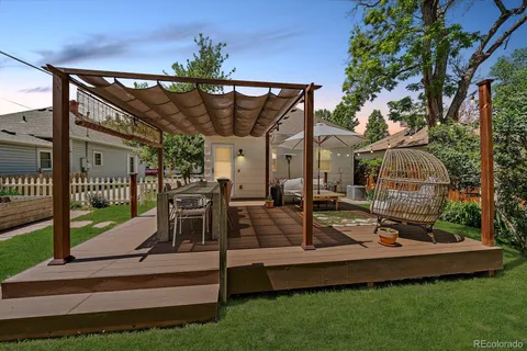 a view of a roof deck with furniture