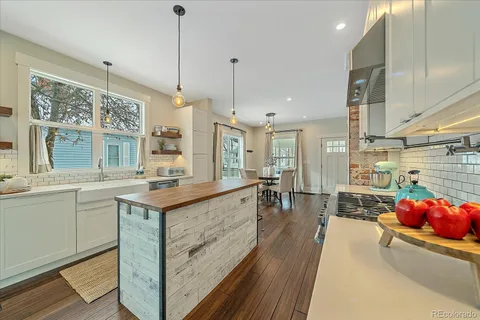 a kitchen with sink stove and cabinets