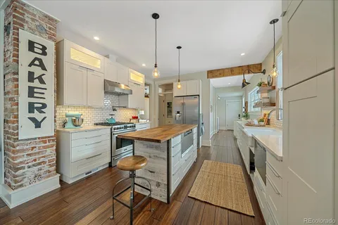 a kitchen with a wooden floor and white appliances