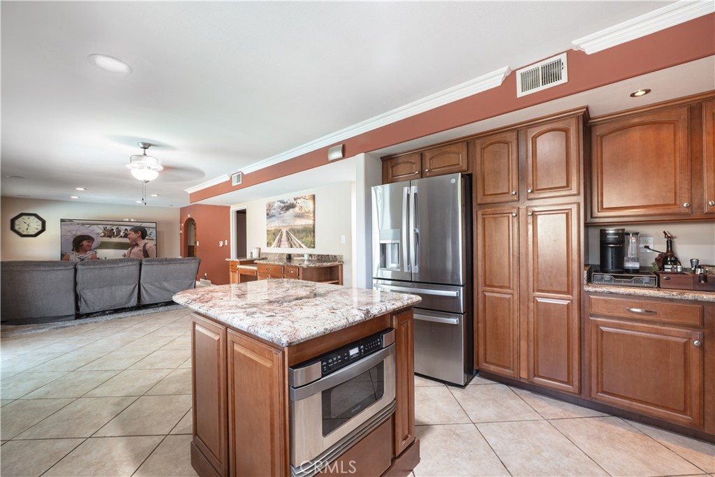 2203 Homewood Avenue Simi Valley, CA 93063 - Photo 9 of 37 a kitchen with stainless steel appliances granite countertop a refrigerator and stove