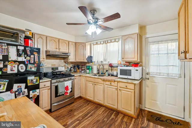 a kitchen with stainless steel appliances granite countertop a stove cabinets and a refrigerator