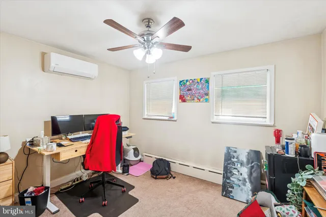 a view of a workspace with furniture and gym equipment