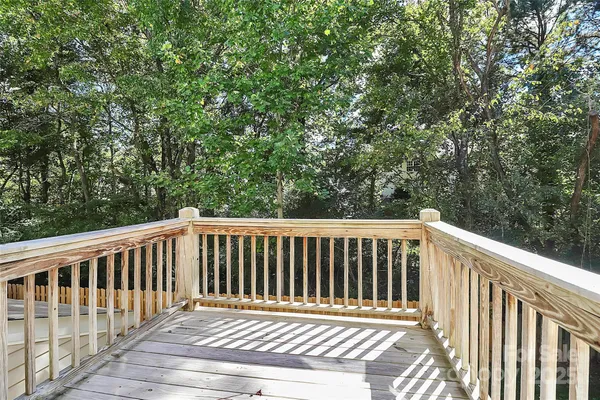 a balcony with wooden floor and fence