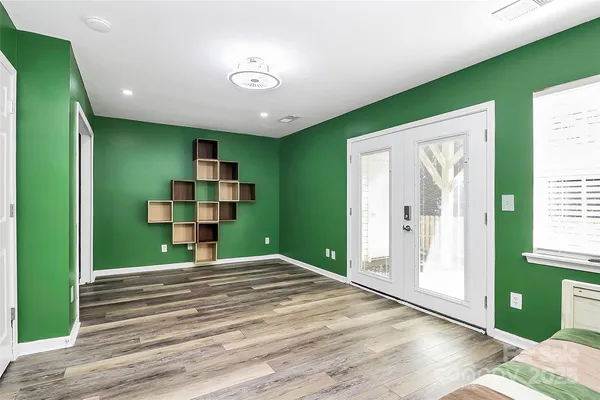 a view of a livingroom with wooden floor windows and entryway