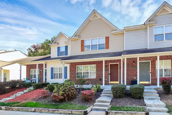 a front view of a house with yard and green space