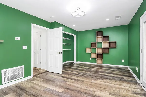 a view of a house with backyard and wooden floor
