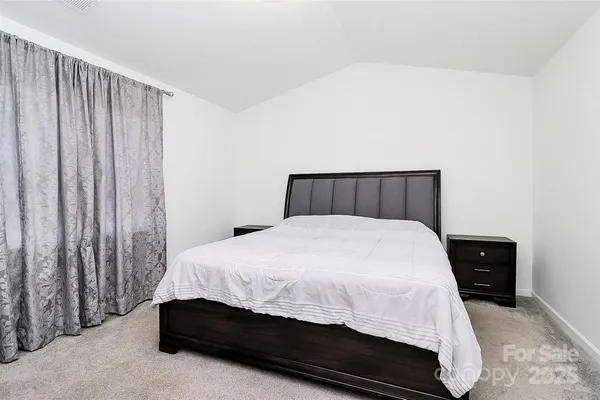 a bedroom with a bed and curtain