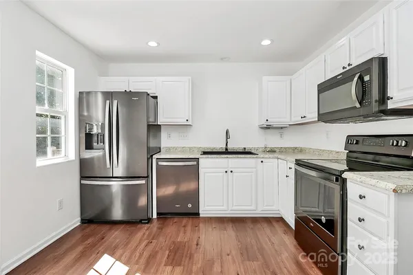 a kitchen with stainless steel appliances a refrigerator stove and microwave