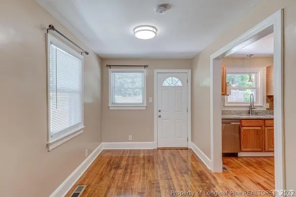 a kitchen with a stove a refrigerator and a sink