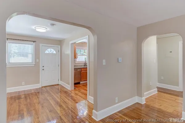 a kitchen with granite countertop white cabinets and a window