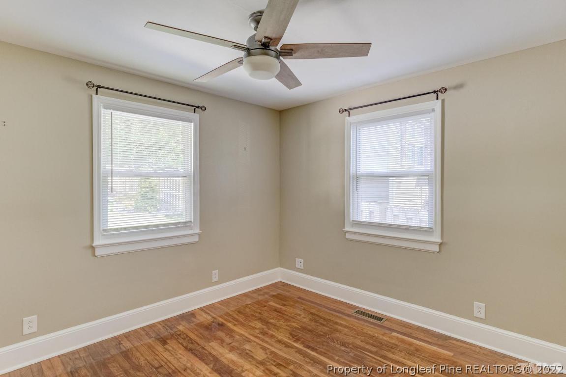 2710 Broad Street Durham, NC 27704 - Photo 25 of 36 a view of an empty room with a window and wooden floor