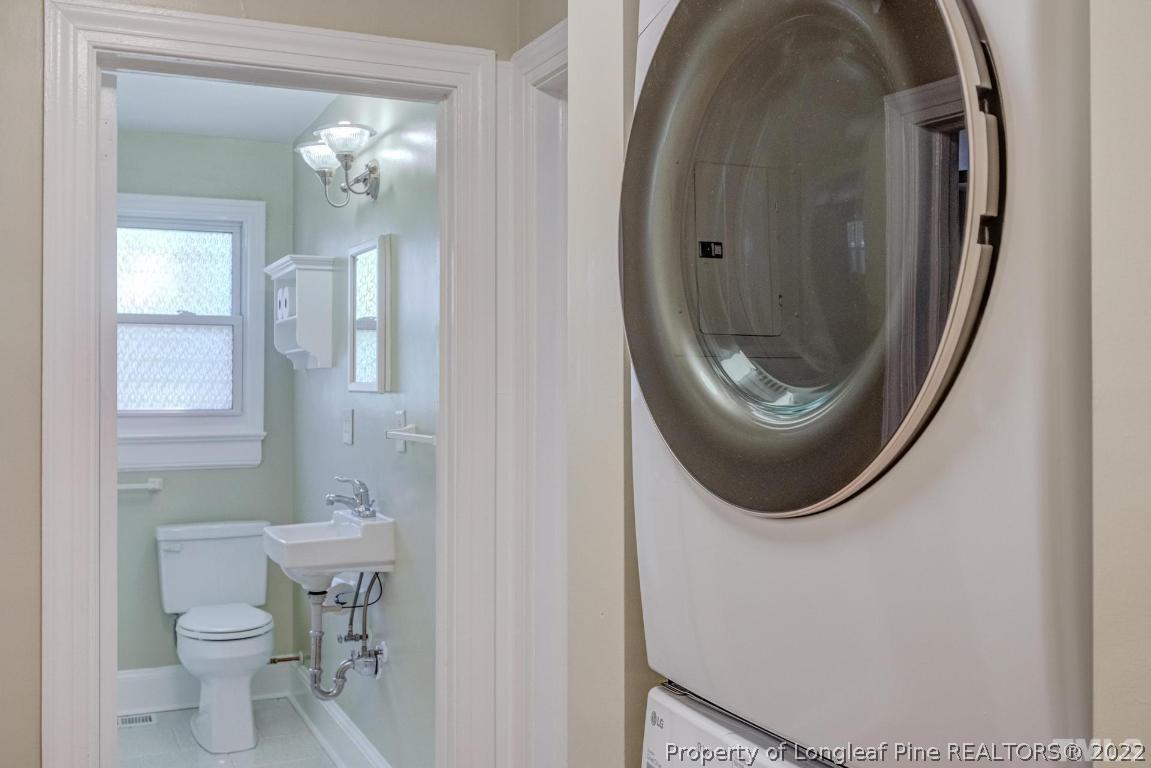 2710 Broad Street Durham, NC 27704 - Photo 28 of 36 a bathroom with a sink a mirror and toilet