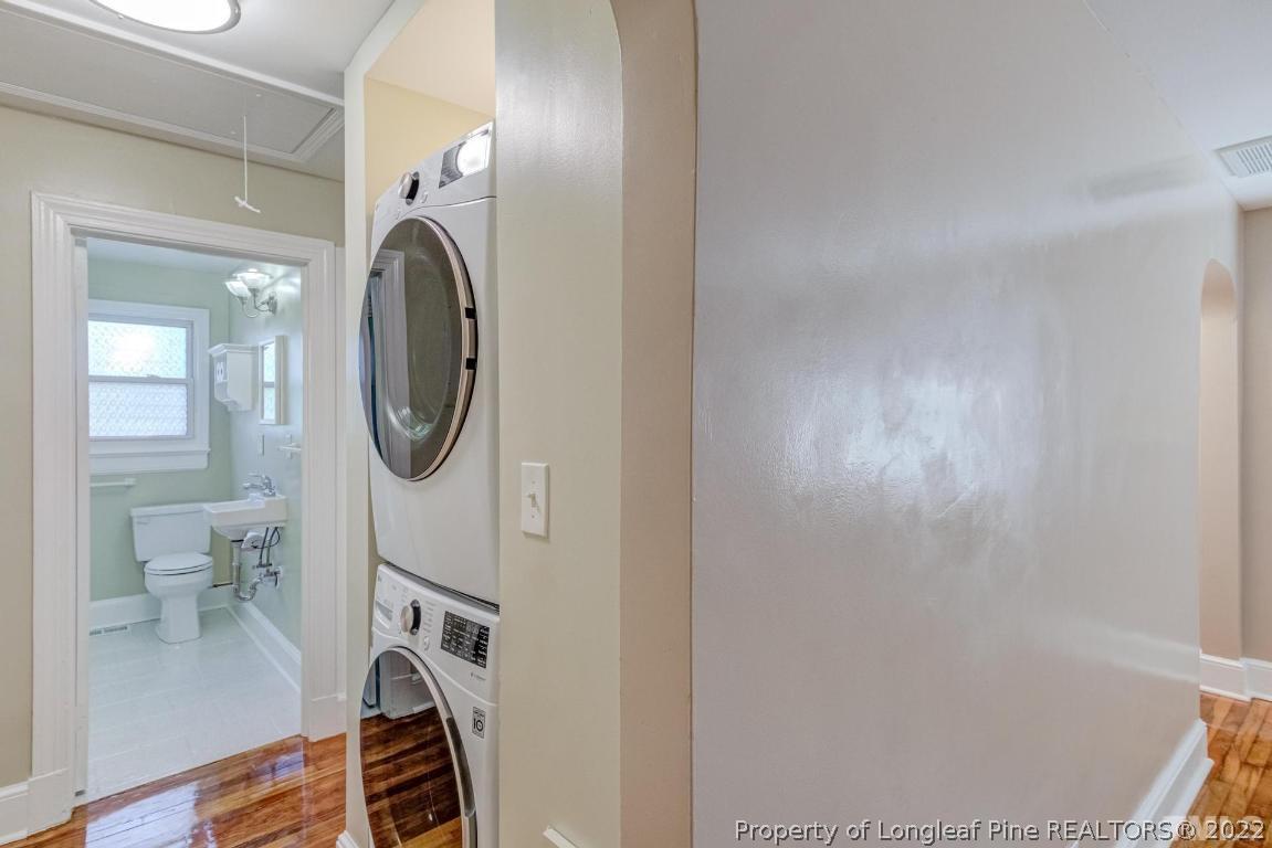 2710 Broad Street Durham, NC 27704 - Photo 29 of 36 a bathroom with a toilet mirror and a sink