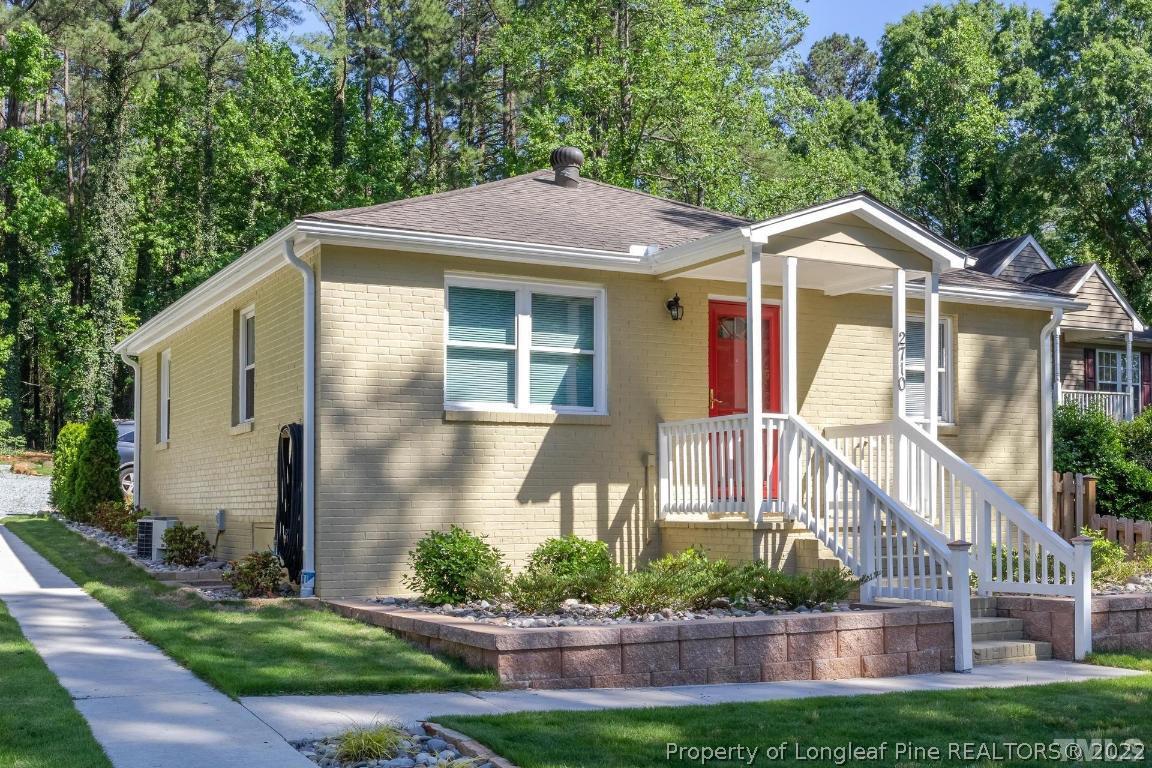2710 Broad Street Durham, NC 27704 - Photo 3 of 36 a front view of a house with a yard and potted plants