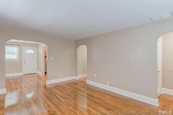 a kitchen with granite countertop white cabinets and a window