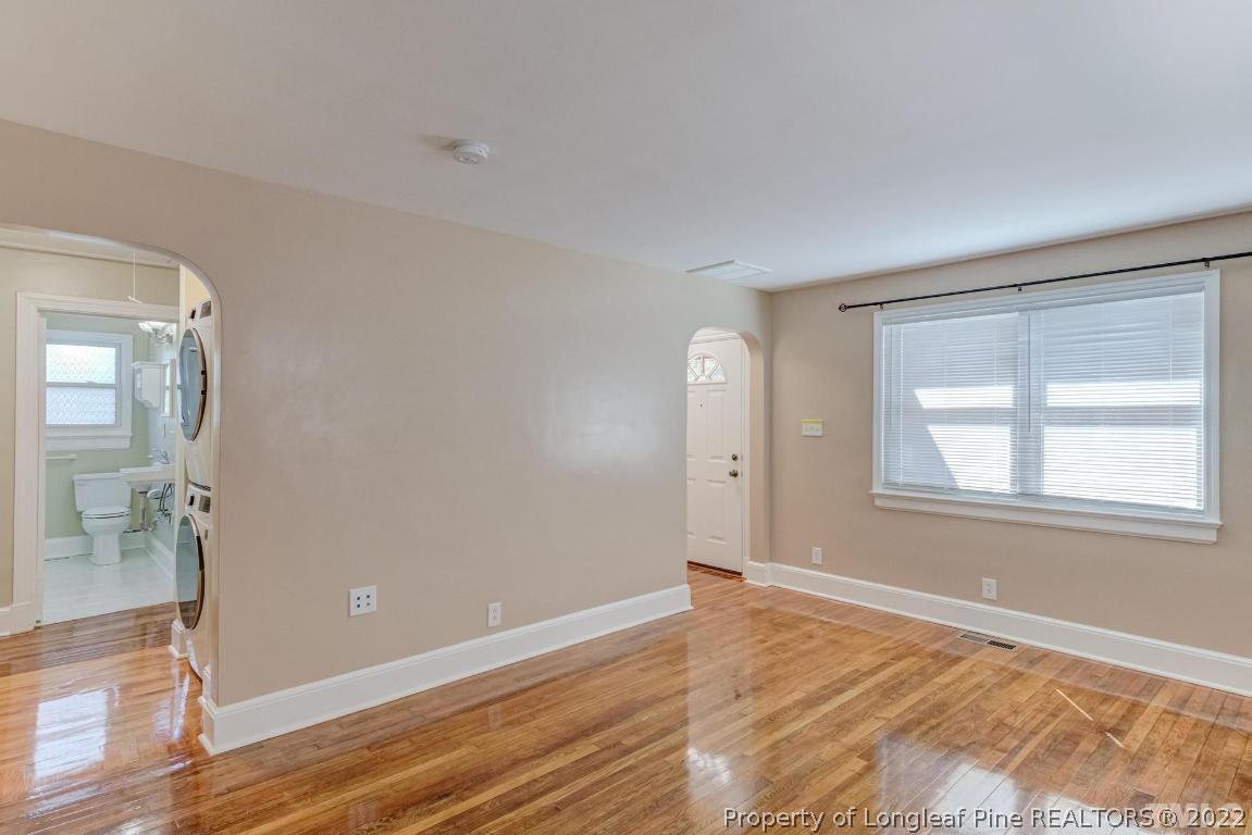 2710 Broad Street Durham, NC 27704 - Photo 10 of 36 an empty room with wooden floor and windows