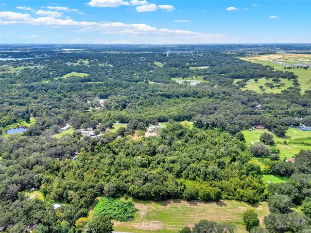 a view of a city with green field