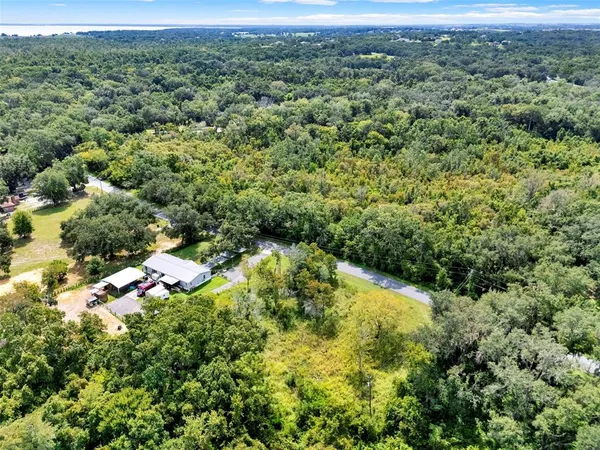 a view of a green yard with an and white house