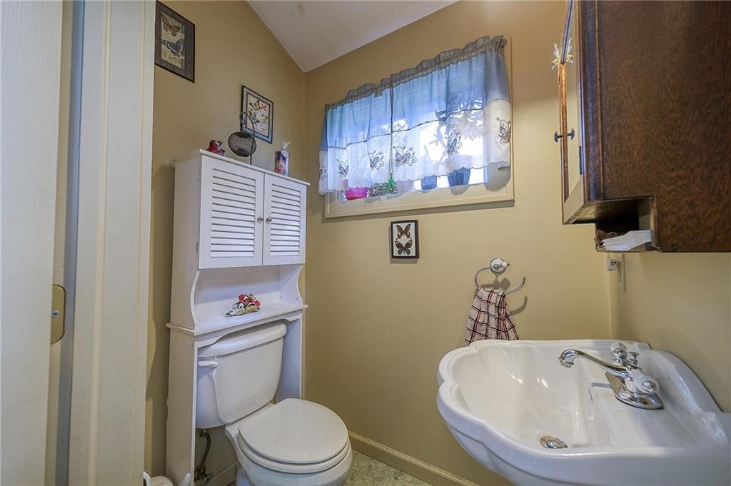 120 Duffield Avenue Pittsburgh, PA 15235 - Photo 12 of 21 a white toilet sitting next to a bathroom sink
