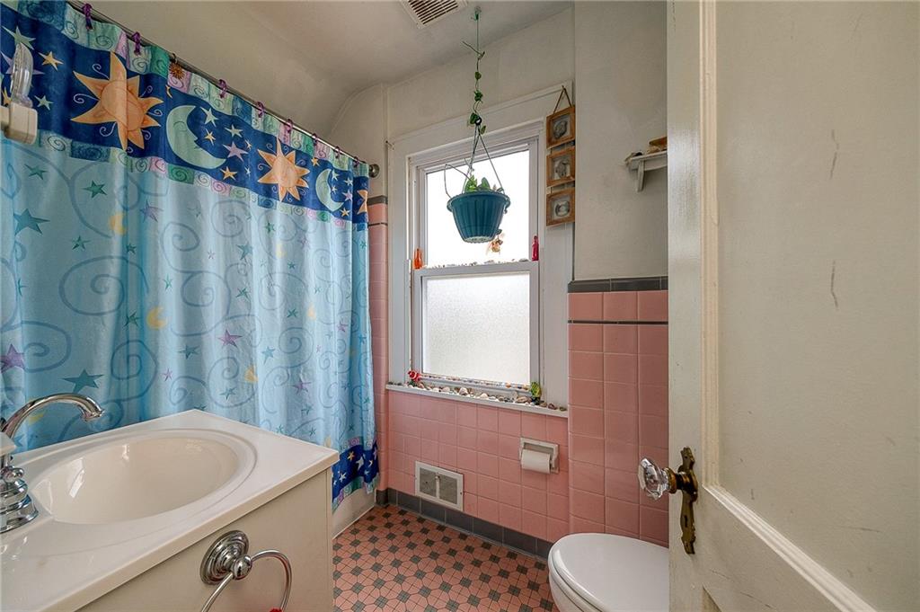 120 Duffield Avenue Pittsburgh, PA 15235 - Photo 18 of 21 a bathroom with a sink a toilet and shower curtain
