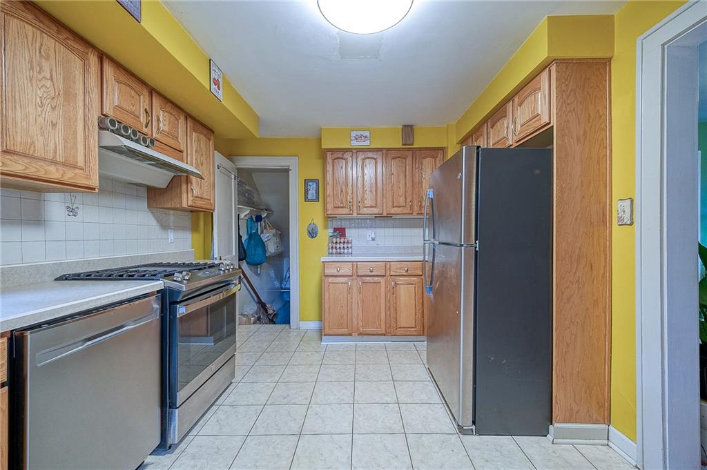 120 Duffield Avenue Pittsburgh, PA 15235 - Photo 10 of 21 a kitchen with stainless steel appliances granite countertop a refrigerator and a stove