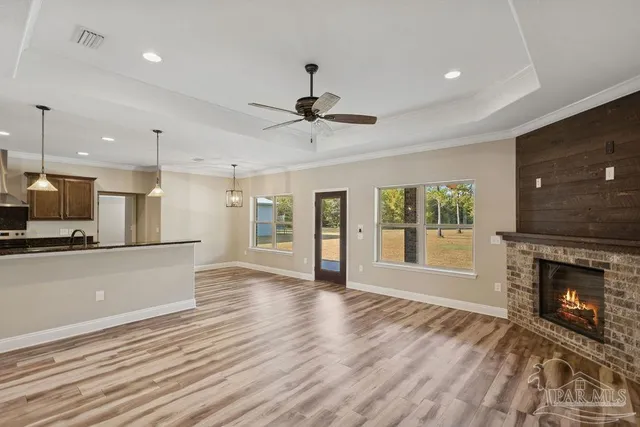 a view of an empty room with a fireplace and a window