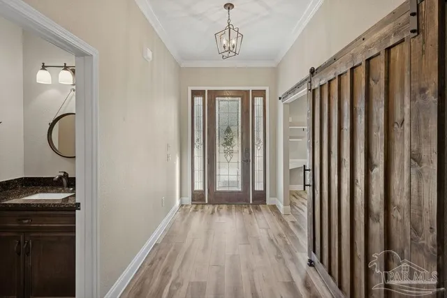 a view of a room with wooden floor and windows