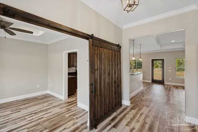 a view of a hallway with wooden floor and closet