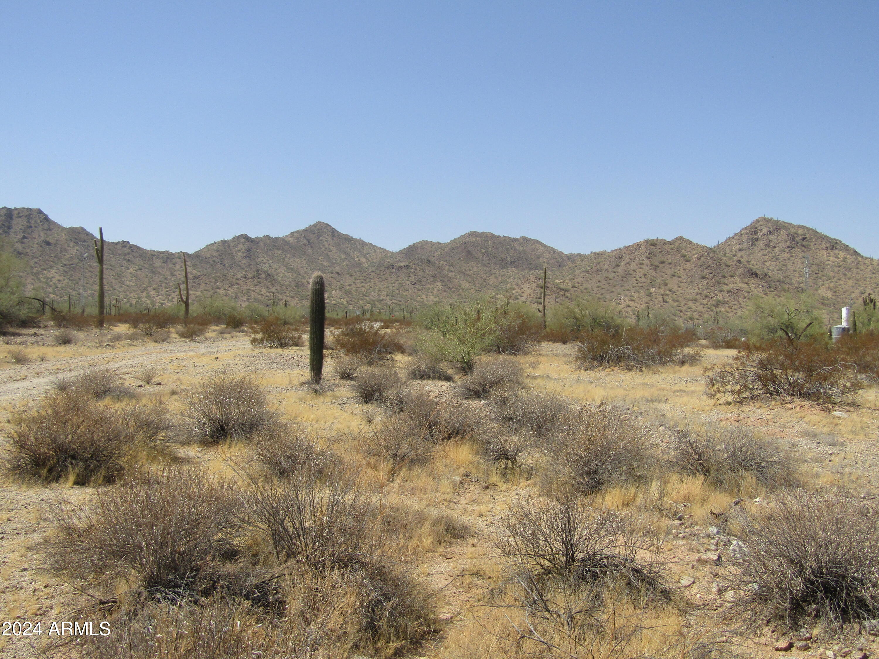 0 West Momoli Road, Unit 24 Maricopa, AZ 85139 - Photo 1 of 11 a view of a dry yard with mountains in the background