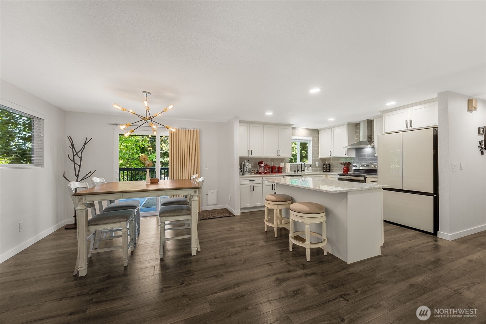 24028 6th Place West Bothell, WA 98021 - Photo 11 of 35 a kitchen with a dining table chairs refrigerator and cabinets