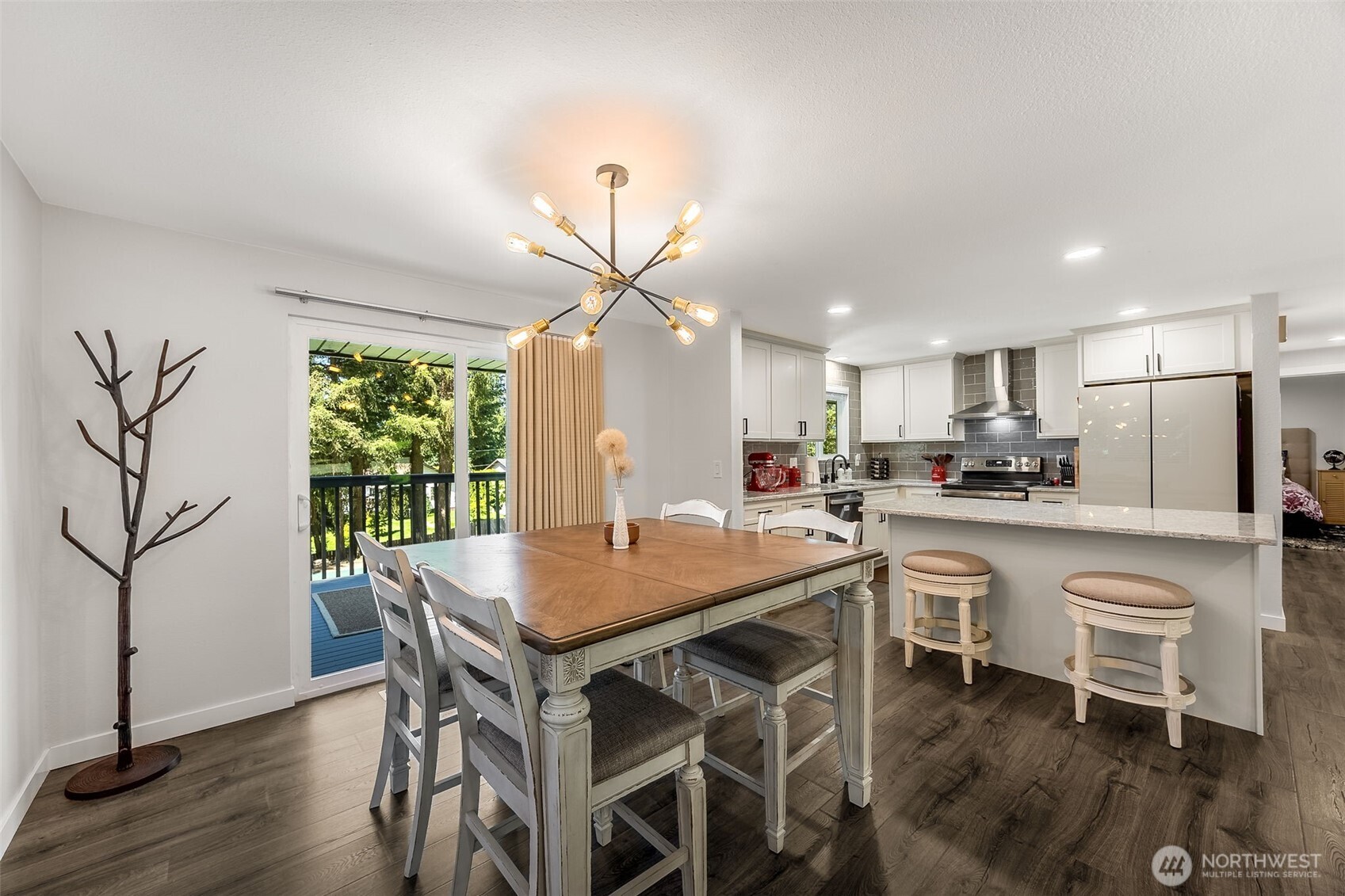 24028 6th Place West Bothell, WA 98021 - Photo 10 of 35 a kitchen with stainless steel appliances granite countertop a dining table chairs and granite counter tops