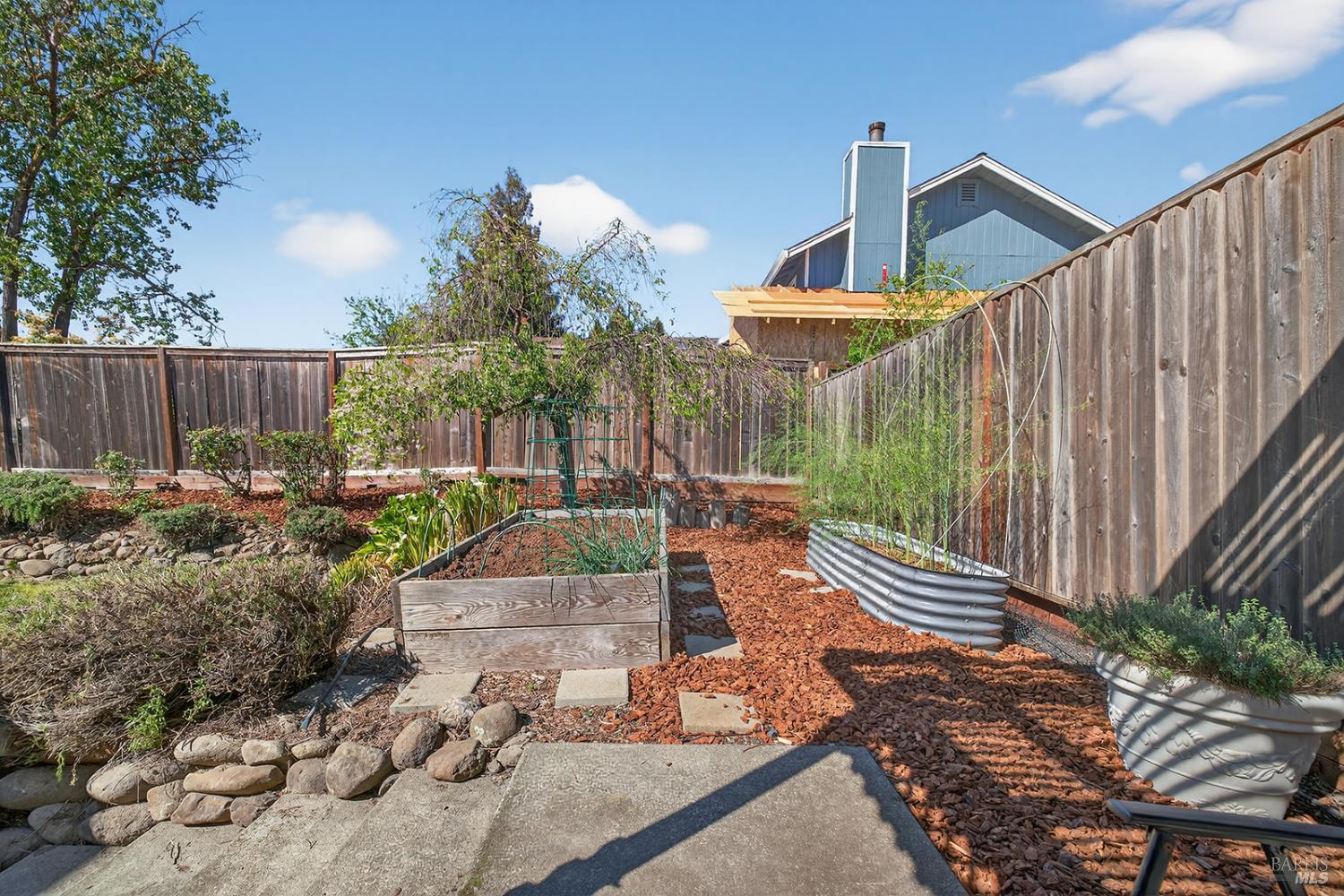5410 Corbett Circle Santa Rosa, CA 95403 - Photo 38 of 41 a view of a backyard with couches plants and wooden fence