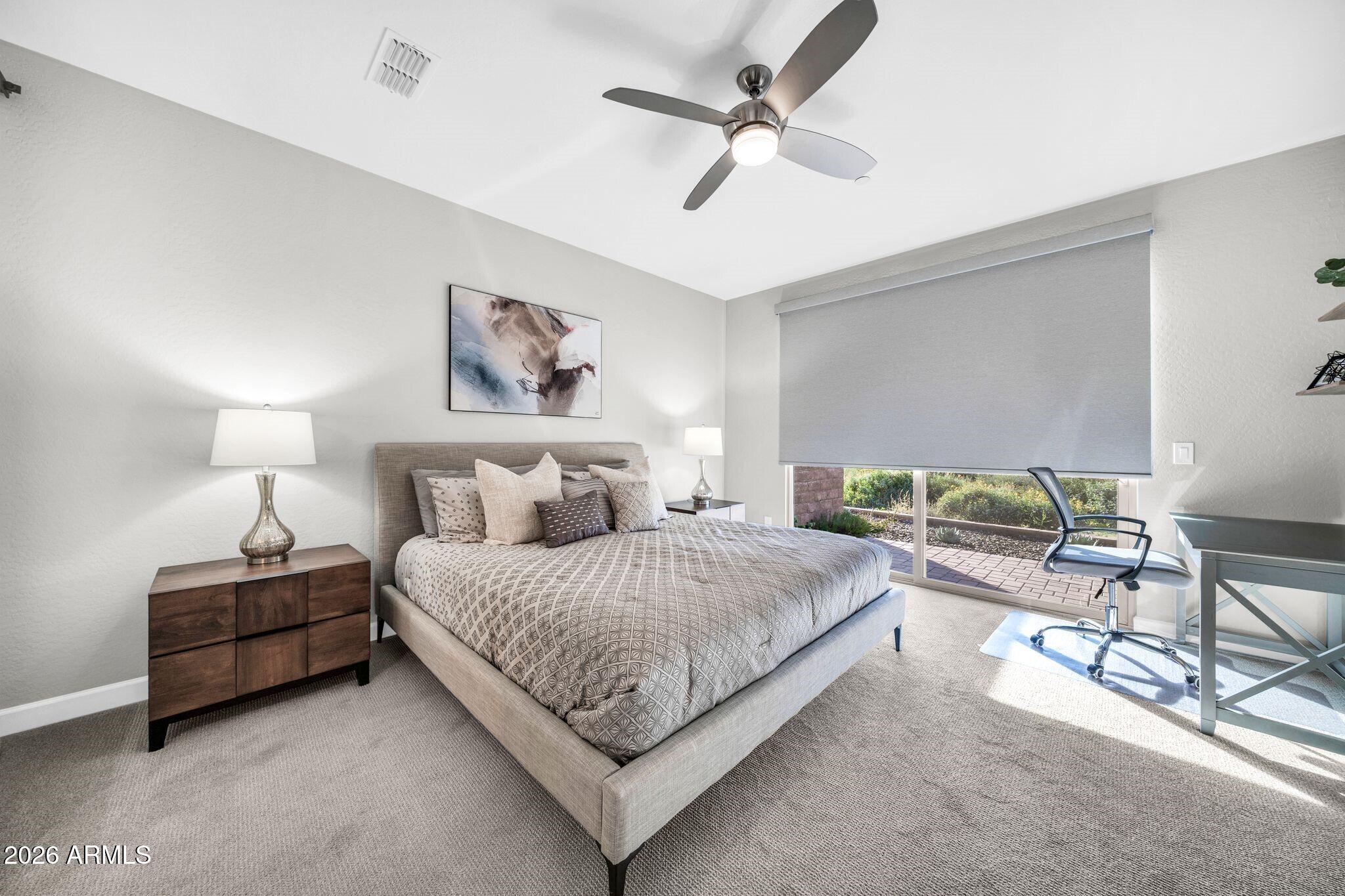 17501 East Cindercone Road Rio Verde, AZ 85263 - Photo 11 of 43 a spacious bedroom with a bed a couch and a chandelier