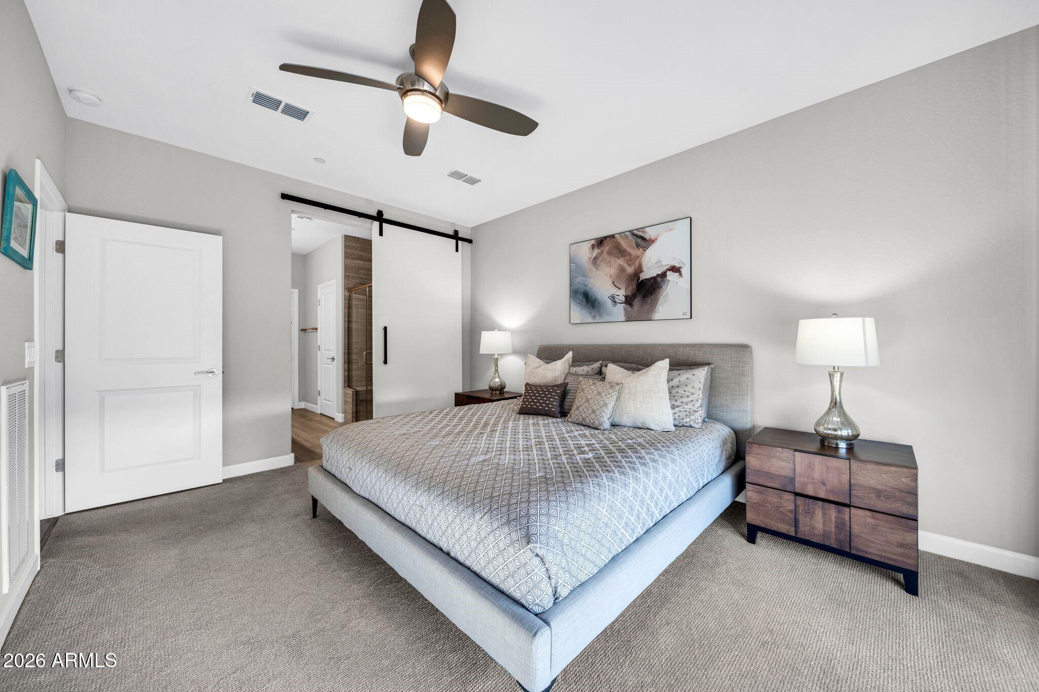 17501 East Cindercone Road Rio Verde, AZ 85263 - Photo 12 of 43 a spacious bedroom with a bed and a painting on the wall