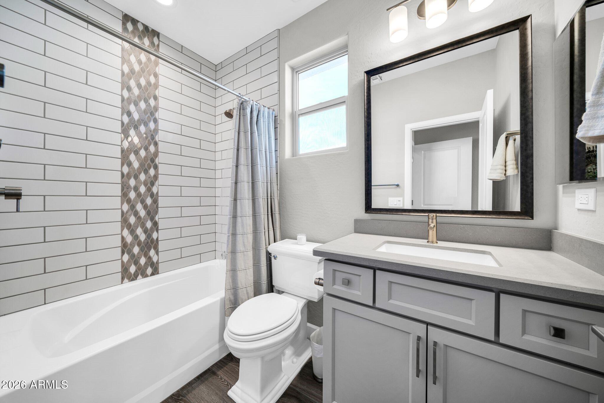 17501 East Cindercone Road Rio Verde, AZ 85263 - Photo 16 of 43 a bathroom with a toilet a sink a tub and mirror