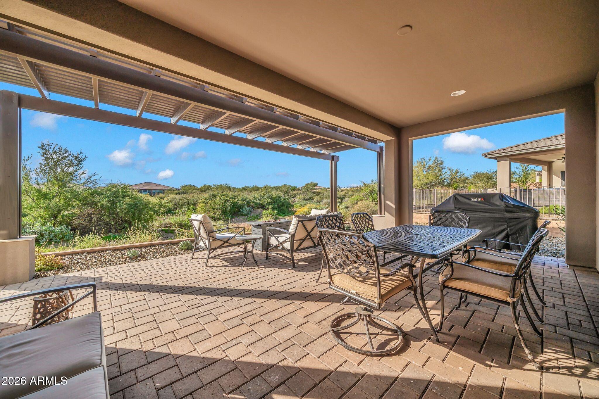 17501 East Cindercone Road Rio Verde, AZ 85263 - Photo 21 of 43 a living room with furniture a rug and a large window