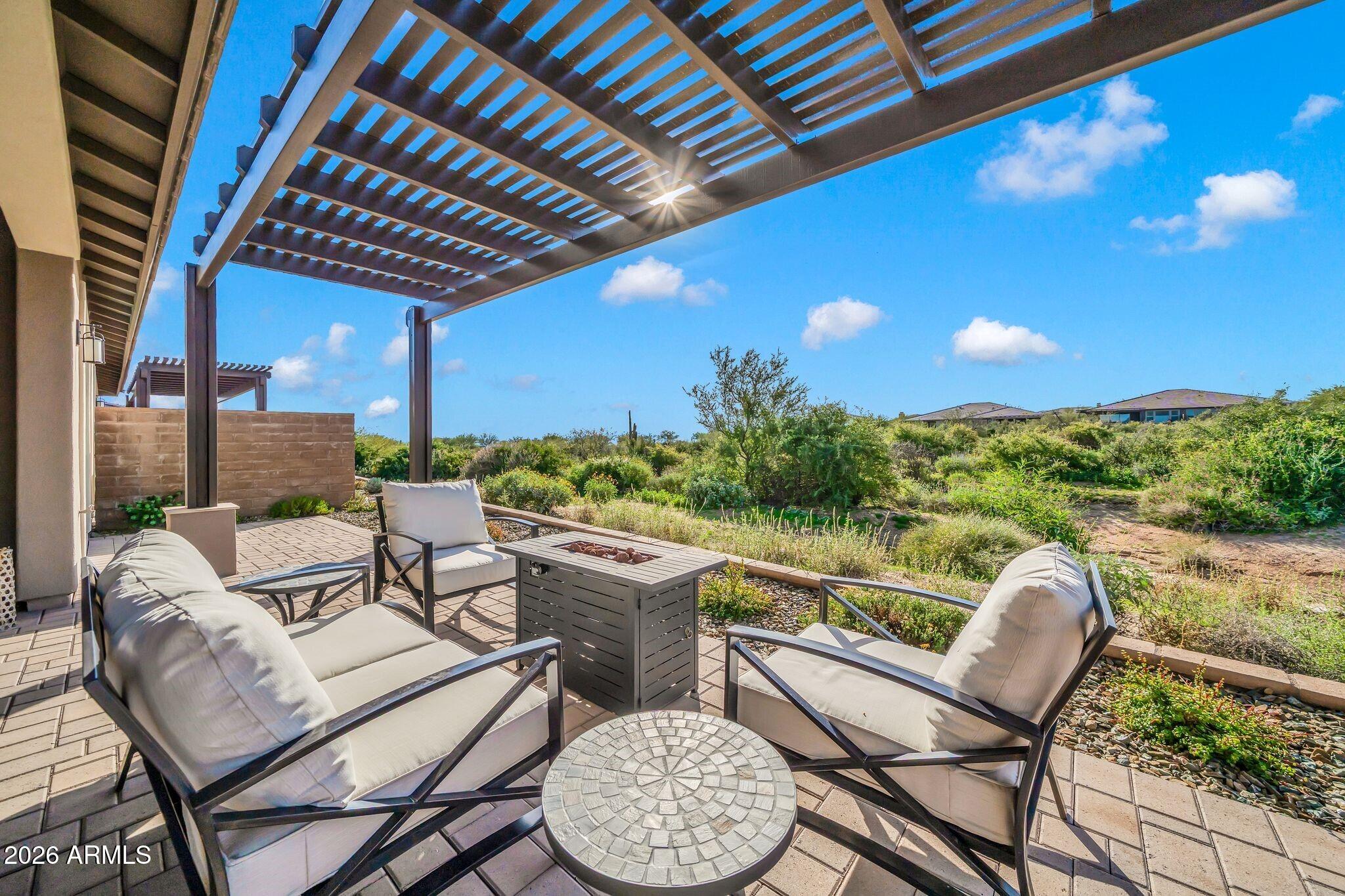 17501 East Cindercone Road Rio Verde, AZ 85263 - Photo 22 of 43 a view of a chairs and table in patio with a backyard