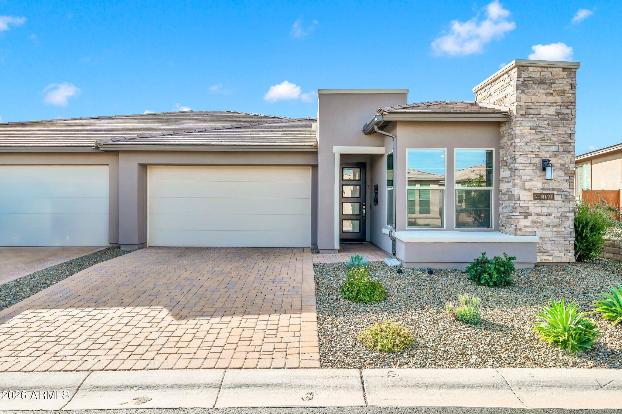 17501 East Cindercone Road Rio Verde, AZ 85263 - Photo 29 of 43 a front view of a house with garden