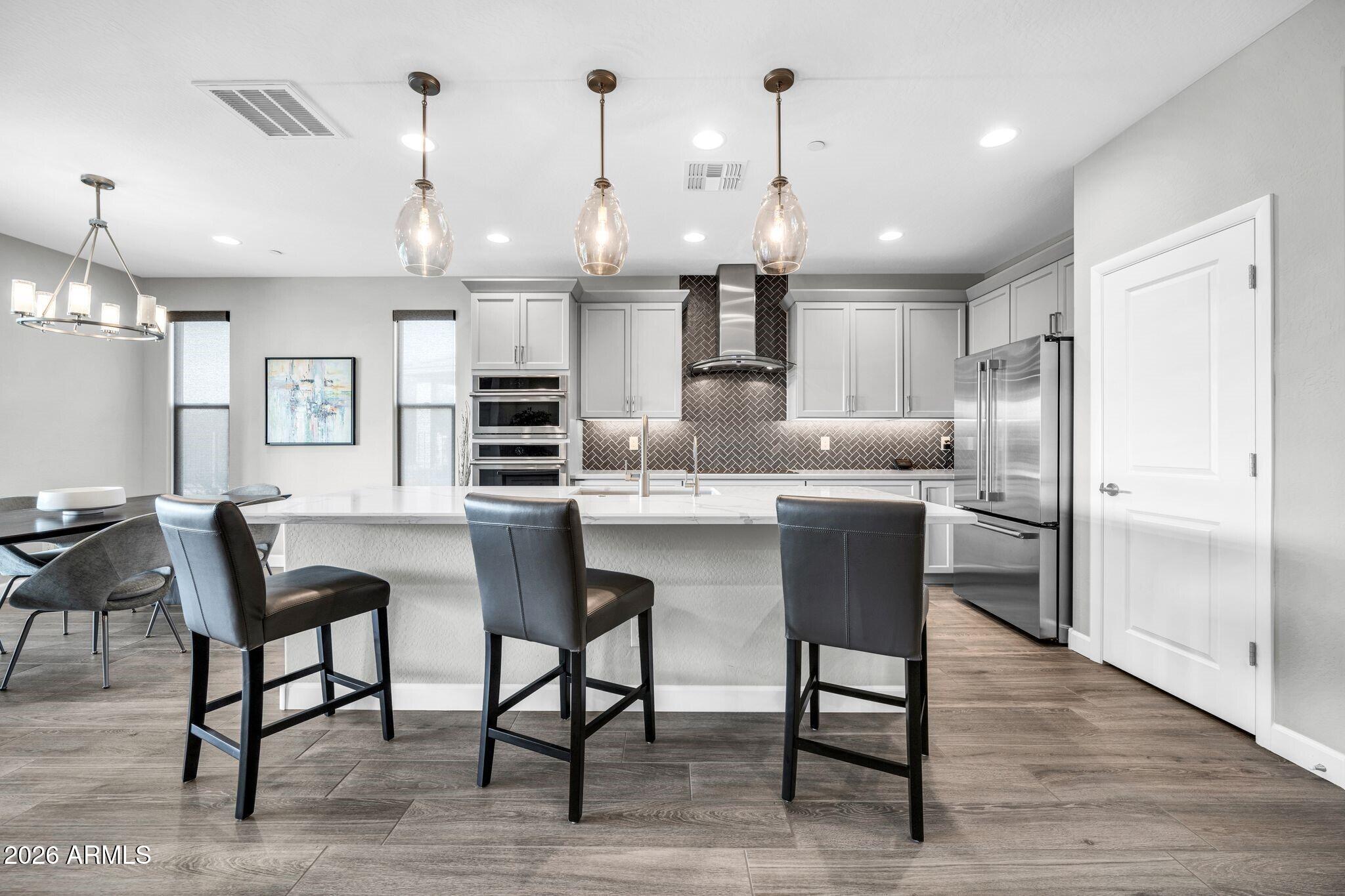 17501 East Cindercone Road Rio Verde, AZ 85263 - Photo 6 of 43 a kitchen with kitchen island cabinets and chairs