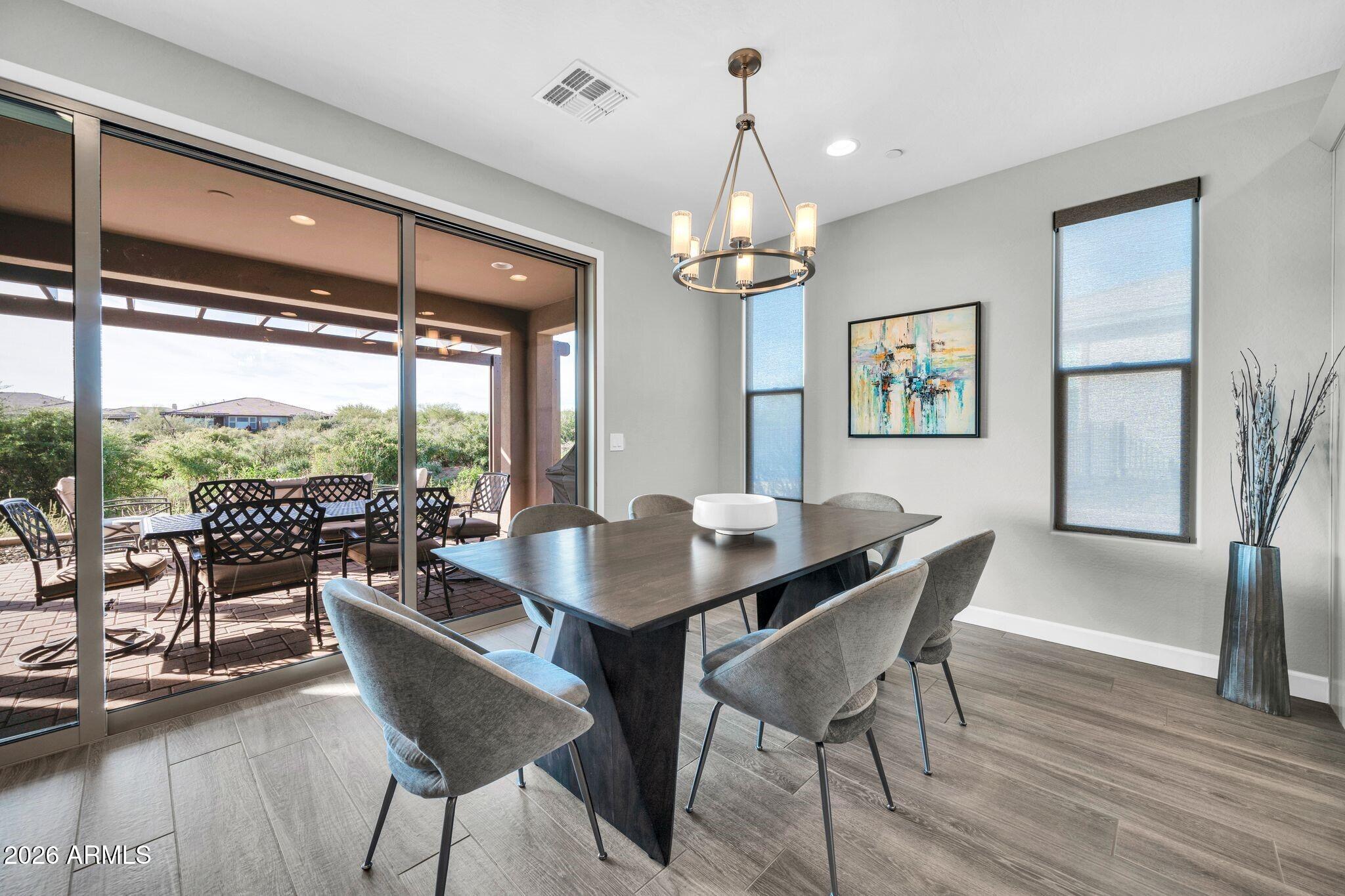 17501 East Cindercone Road Rio Verde, AZ 85263 - Photo 8 of 43 a view of a dining room with furniture window and wooden floor