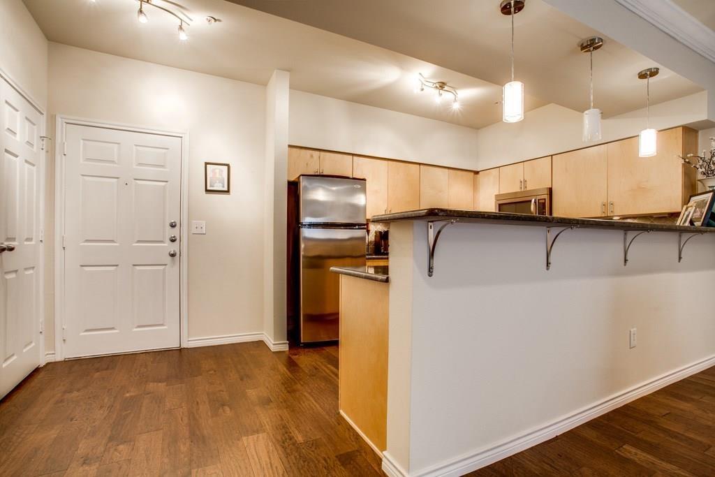 3102 Kings Road, Unit 3310 Dallas, TX 75219 - Photo 7 of 19 a view of a refrigerator in kitchen and a room